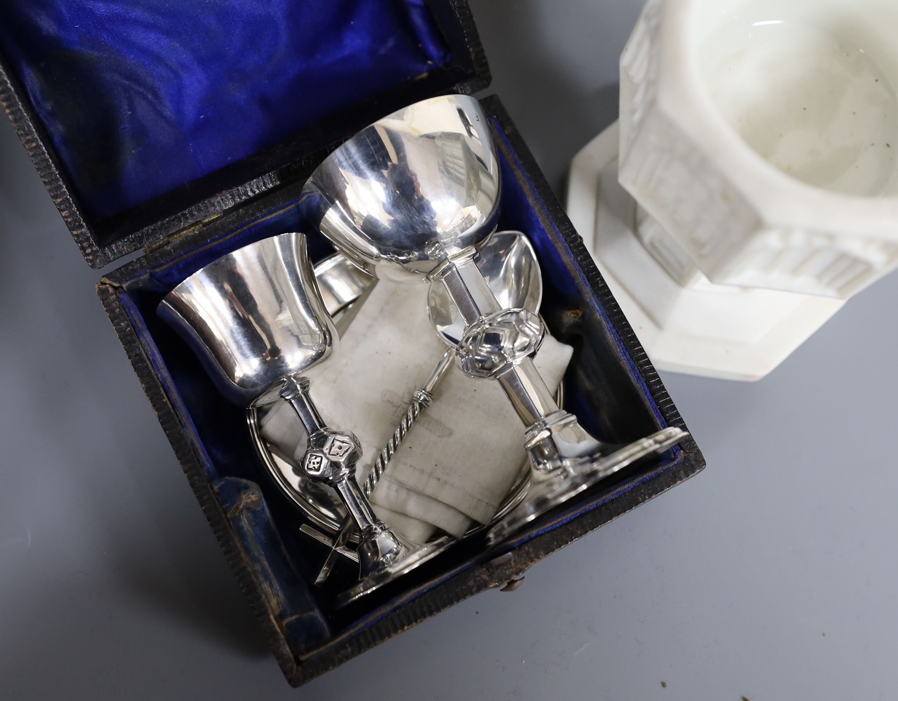 A Victorian Parian baptismal font, 11cm, and a Victorian silver travelling communion set, both cased